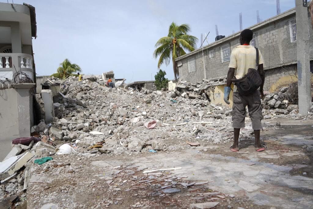 Man stares at rubble of a building in aftermath of 2021 Haiti earthquake