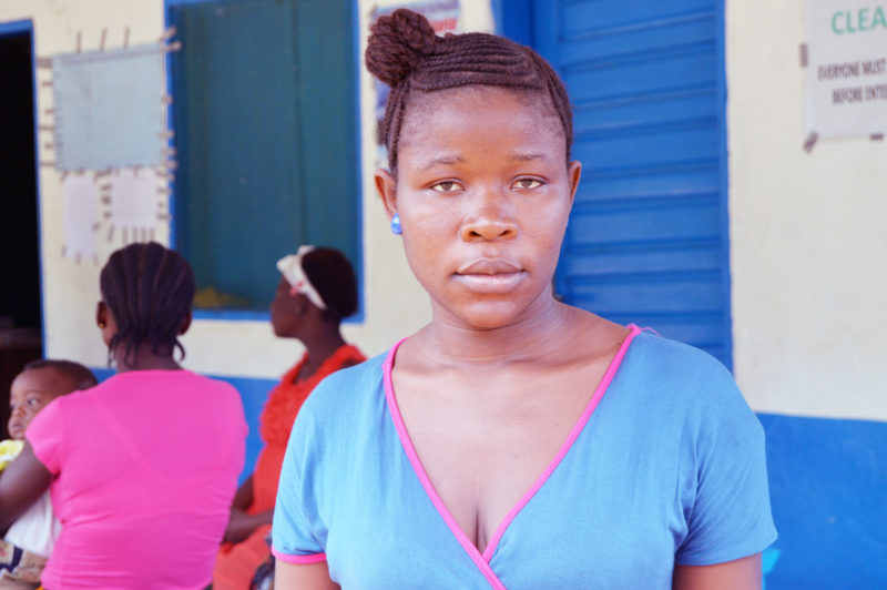 Massa, a resident in Liberia, posed outside the medical clinic where she is now a member of the quality improvement team