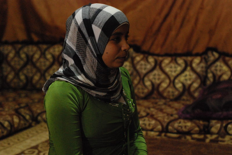 Mariam, a young girl who is a Syrian refugee, sitting in her new home in Lebanon