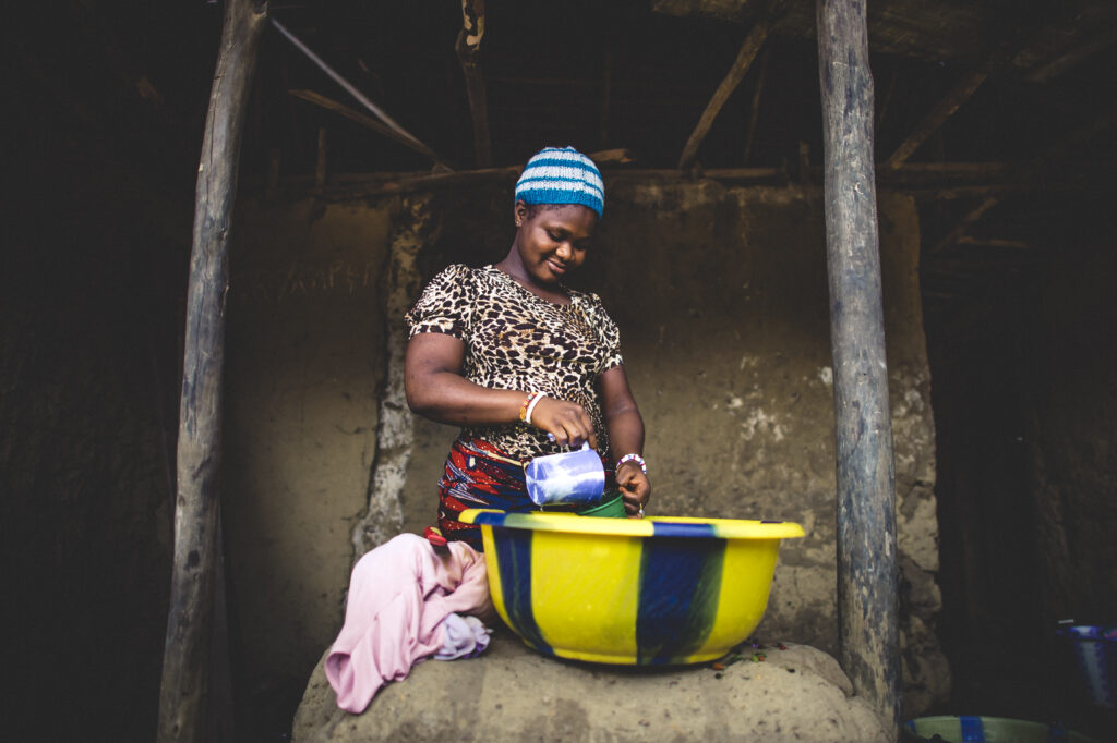 Assatu’s doing housework in her home in Liberia.
