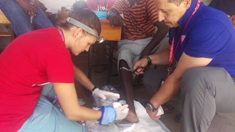 Volunteers and staff work together to treat patients in the mobile medical unit