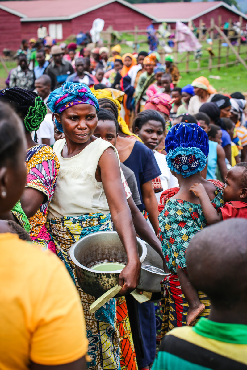 South Sudanese refugees arriving in Uganda wait in line for Medical Teams to do health intake by a Medical Teams staff member