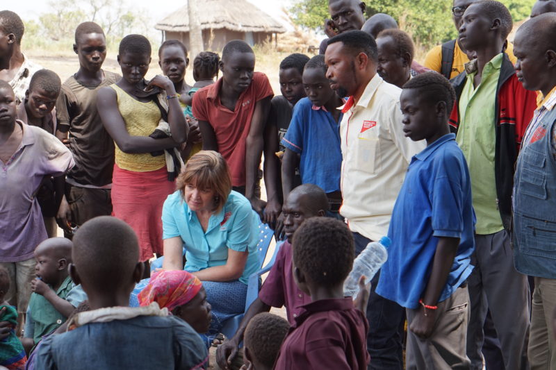 Martha, the President and CEO of Medical Teams International, sitting among the refugees in Uganda