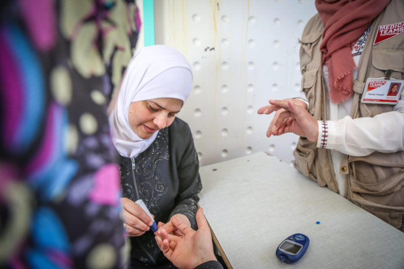 A volunteer helping provide medical care and check-ups for Syrian refugees