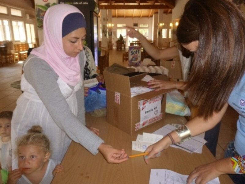 A Medical Teams volunteer giving Infant Survival Kits to a mother in Greece