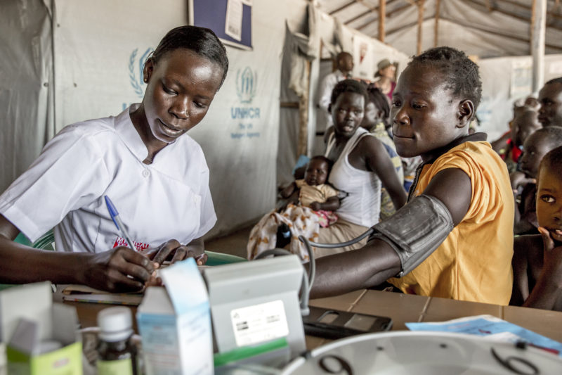 A Medical Teams nurse checks the blood pressure of a refugee at the Palorinya Refugee Settlement in northern Uganda