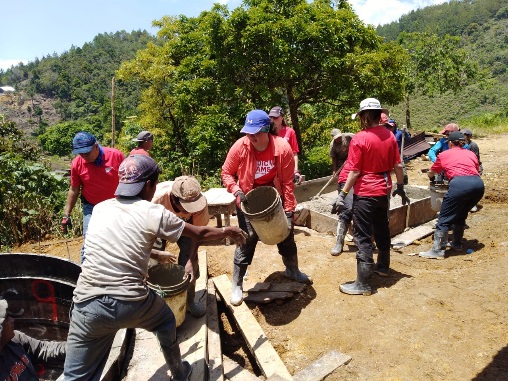 Volunteers work alongside locals to build a water system in Guatemala