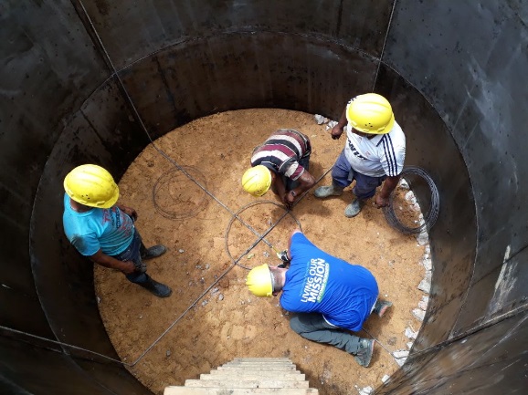 Volunteers and locals dig a water system