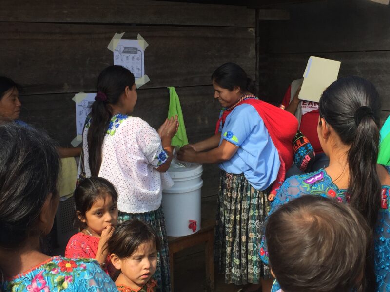 Local Guatemalan children and mothers learn about handwashing