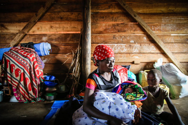 Mama Janine holding her baby that she gave birth to upon arriving in the Ugandan refugee camp