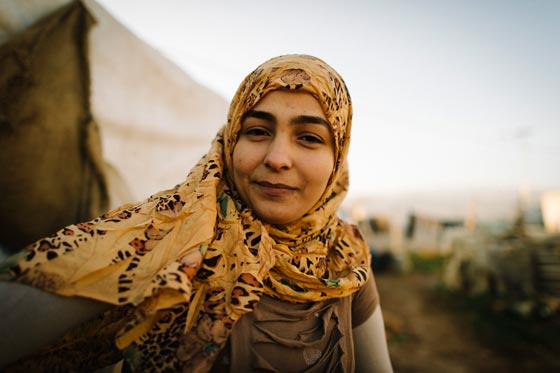 Kareena, a Syrian refugee, who longs to finish her education in Syria, is posed in her refugee camp