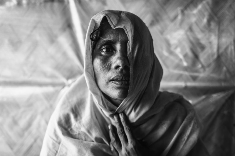 Nosima, a Rohingya refugee woman, sitting in a medical team's clinic 