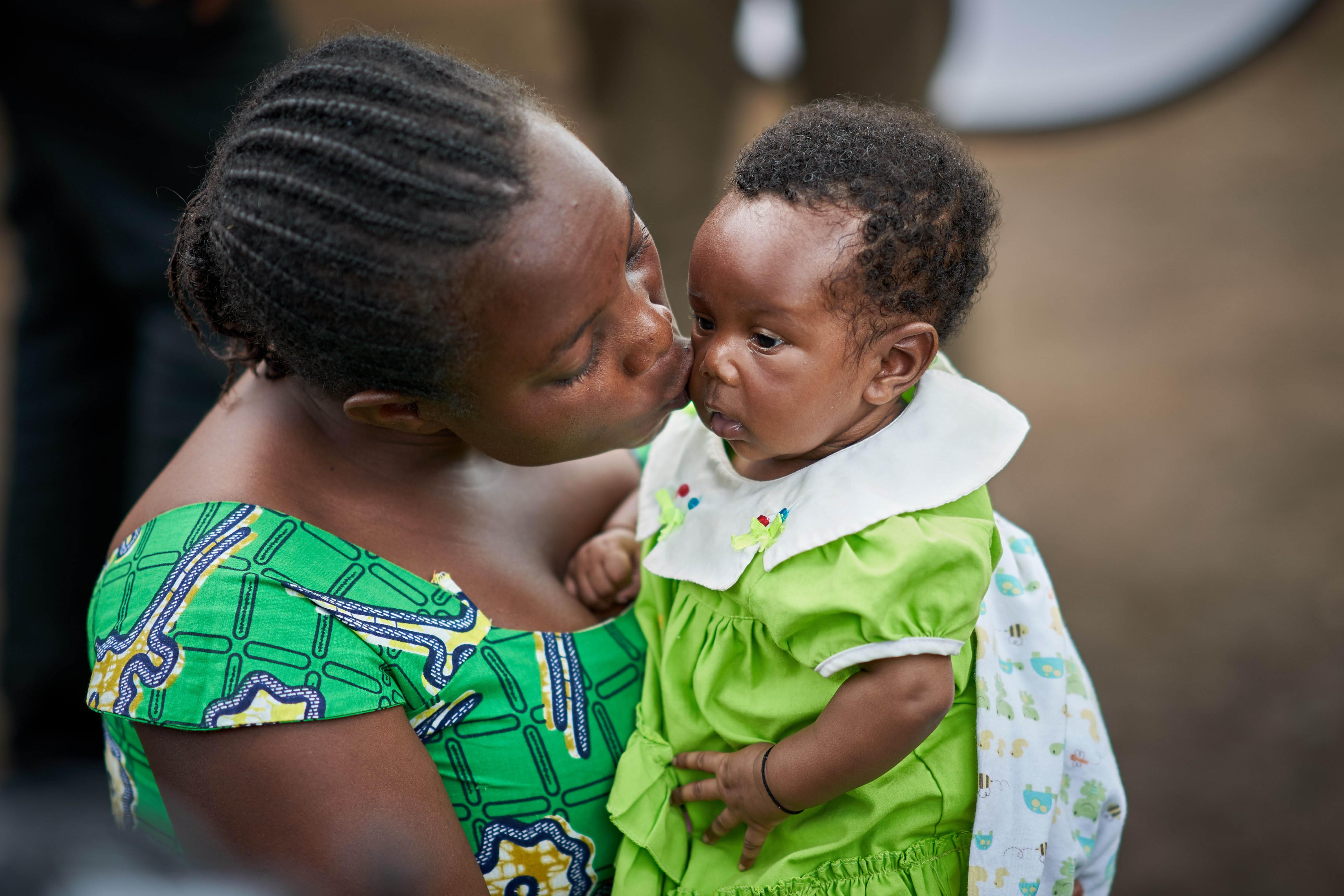 Janet kissing her baby Vanessa, after losing two babies to improper pregnancy care