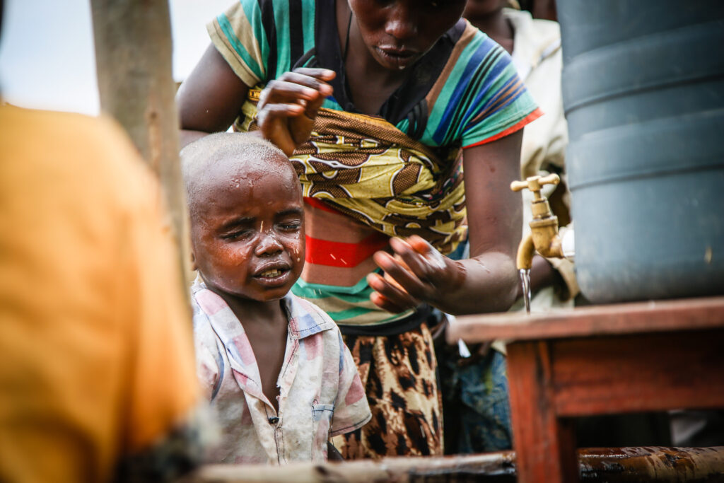 Refugees are screened at the border into Uganda with a sanitation screening as part of the DRC response to protect against Ebola, 2018.