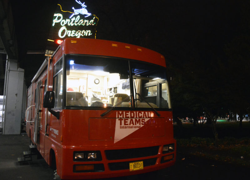 Mobile Dental van parked in front the Portland Oregon White Stag Sign