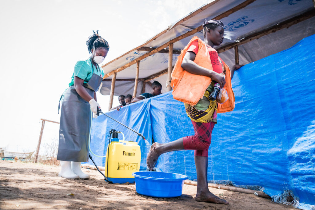 Refugees are screened at the border in Kyangwali, Uganda, with a sanitation screening as part of the DRC response to protect against Ebola, 2018.