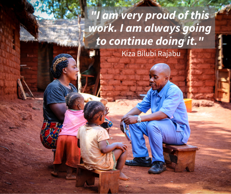 Kiza, a refugee and a Health Information Team volunteer, talking with his two daughters and wife in their refugee camp