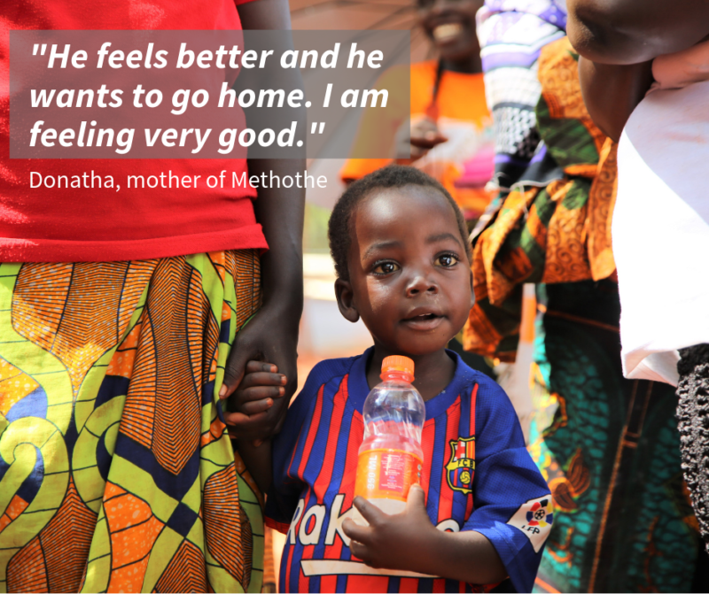 Methothe, a refugee boy, holding hands with his mother after receiving life-saving medical care for his malaria