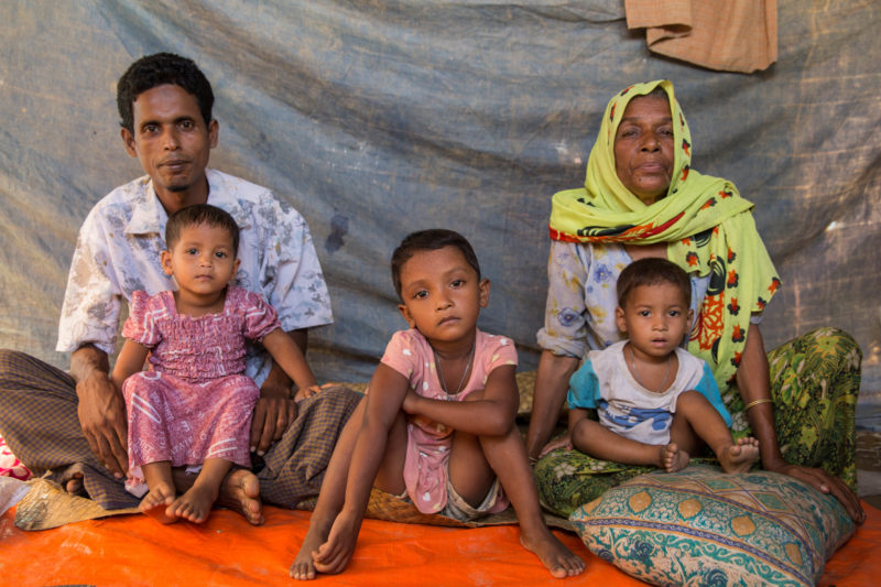 Syrian refugee family sitting inside their tent in a refugee camp in Bangladesh
