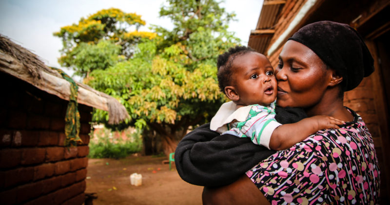 Suzanne kissing her baby Rwamba, who’s named after her other child that died from malaria