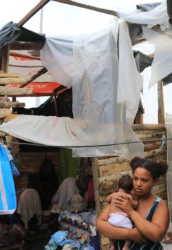 Stefanie and her child outside of their home in Colombia