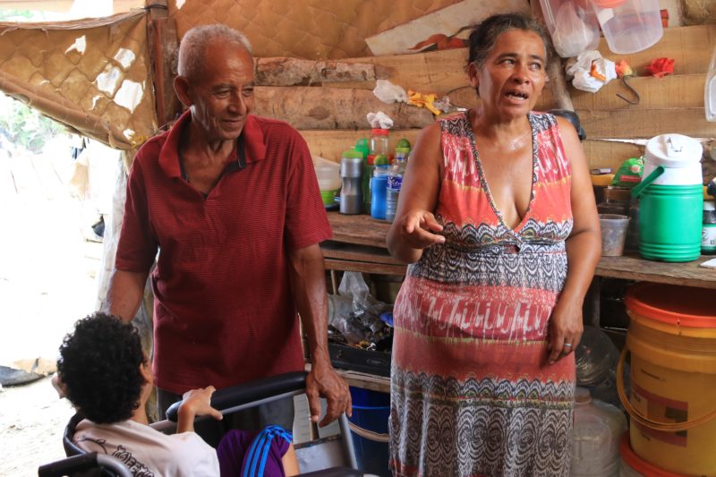 An elderly couple living in the settlement, taking care of their handicap daughter