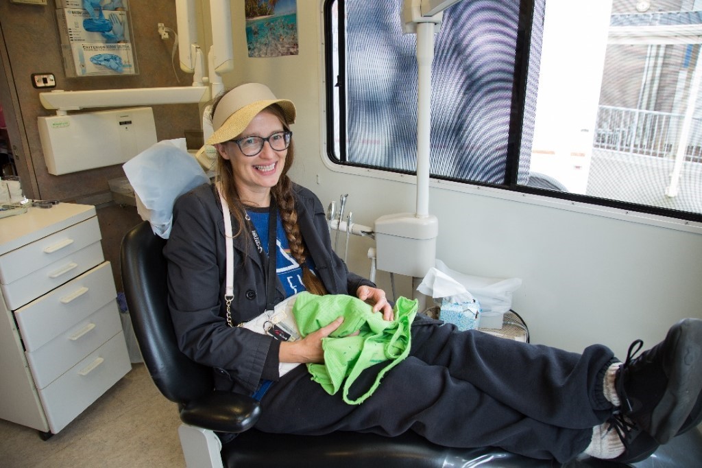 Mary, a Seaside Mobile Dental patient, sitting in a dental chair waiting to be checked out