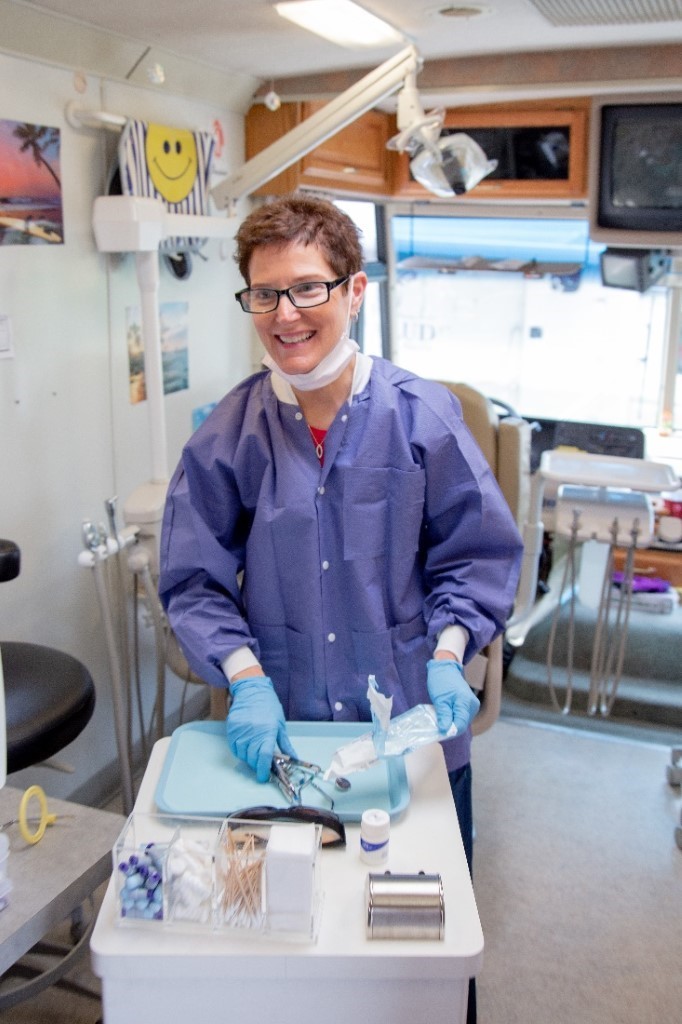A volunteering hygienist in one of the mobile dental vans at a mobile dental clinic in Portland, Oregon
