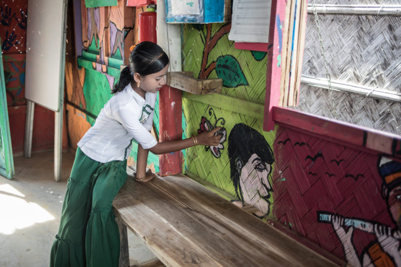 Maisara, one of the Rohingya refugee girls, showing her art from art therapy 