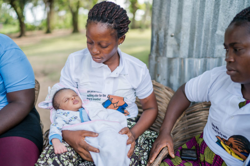 Abigail, a Liberian woman, holding her newborn daughter, Miracle