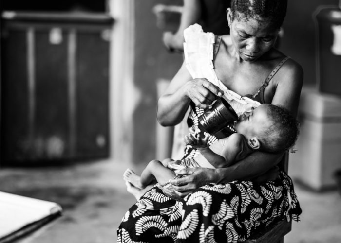 A Liberia mother, Mondamar, feeds her newborn son, Mustafa