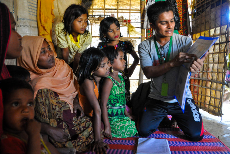 Redwan, a community health worker, visiting families in his community to teach them about health and sanitation