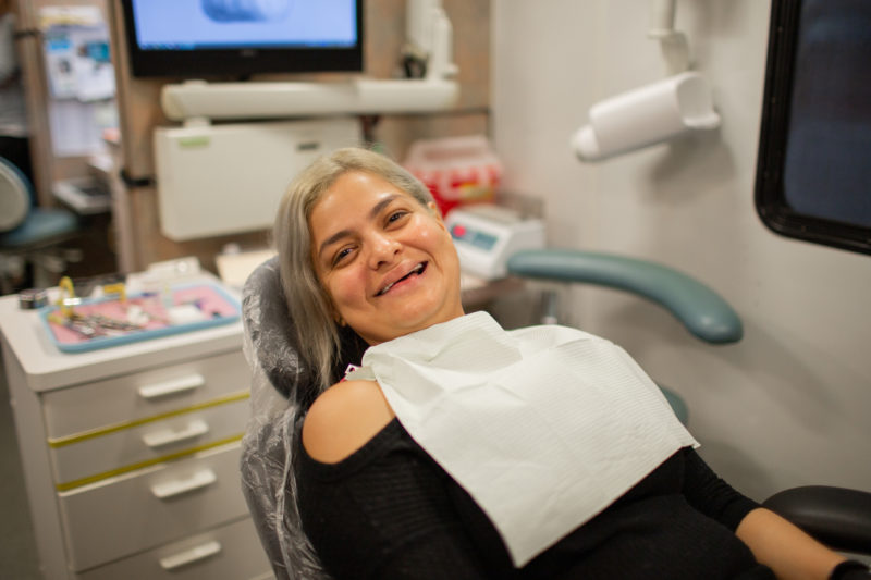 Jenny, sitting in the patient chair in the Mobile Dental van waiting for her filling procedure