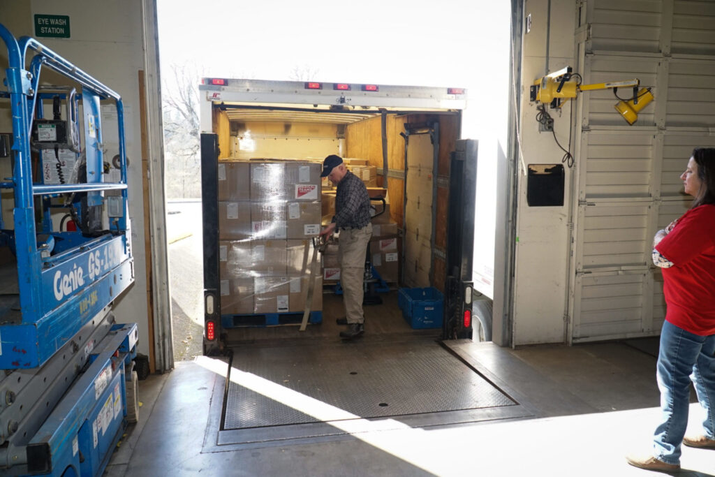 A Medical Teams employer loading Personal Protective Equipment onto a truck