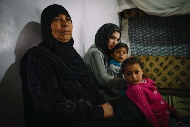 syrian refugee, Noura, with her family in their home