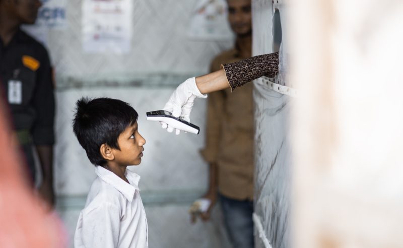 Bangladesh, boy getting temperature taken