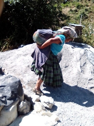 woman carry heavy burden on back