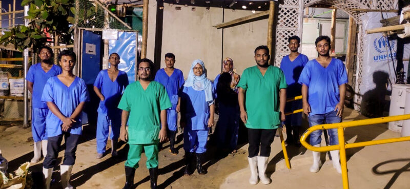 A team of ten health workers stand outside the isolation and treatment center in Bangladesh.