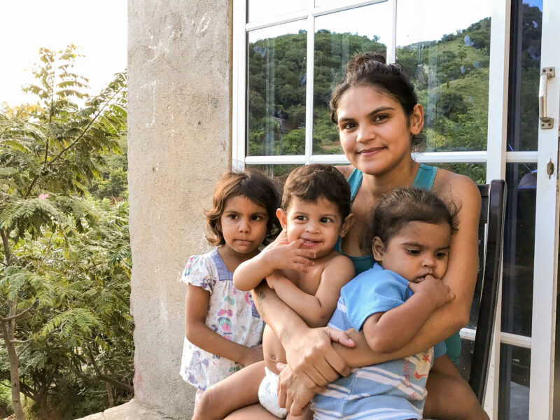 In Santa Marta, Colombia, Daimerlyn sits with her three children.