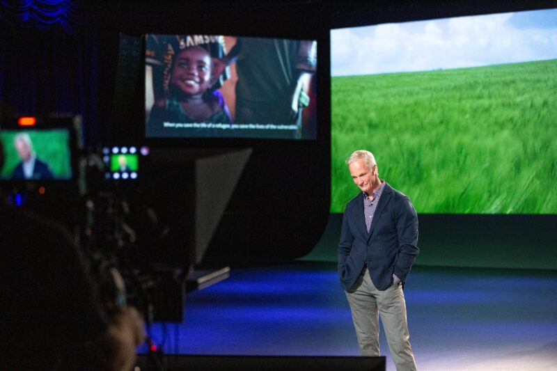 Presenter John Curley standing alone on the set of the virtual FIeld of Dreams event experience.