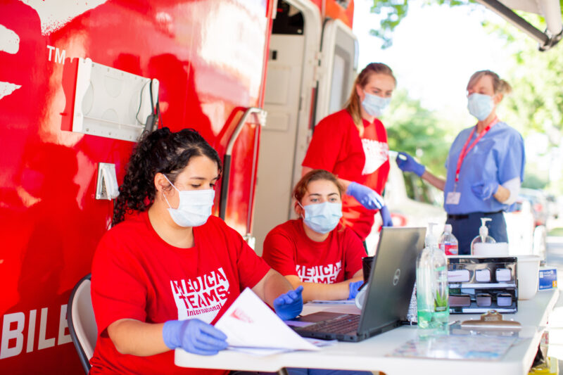 Volunteers and staff at a COVID-19 testing clinic organizing paperwork in Seattle, Washington.