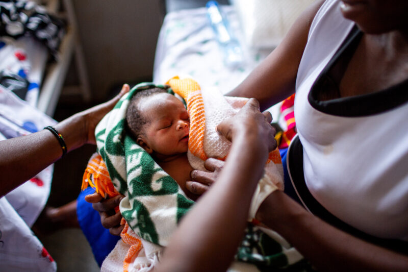 Florence Emee holds her baby son, born three days earlier in a maternal health ward in Kyangwali