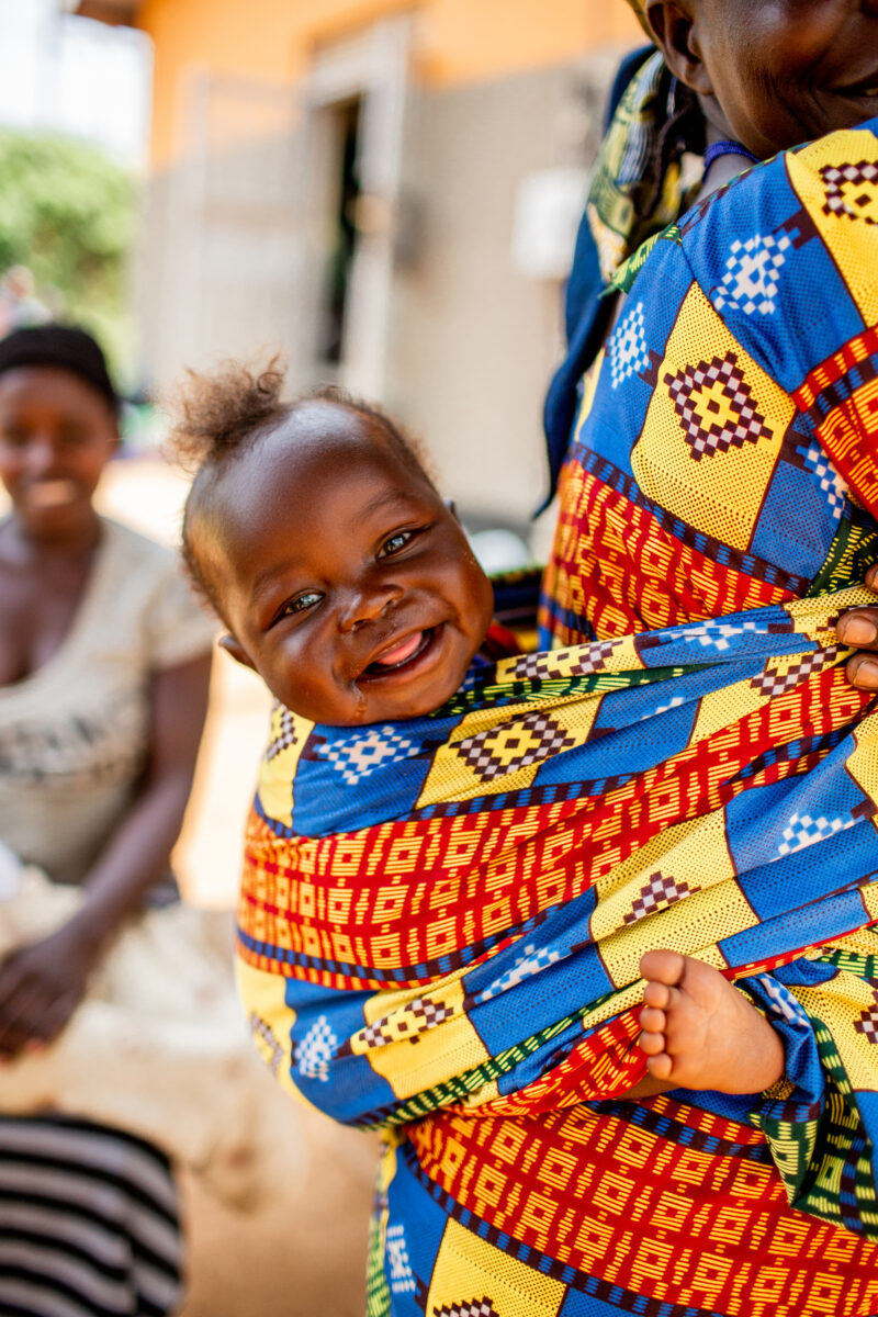 A happy baby smiling at the camera in Kyangwali Uganda. 