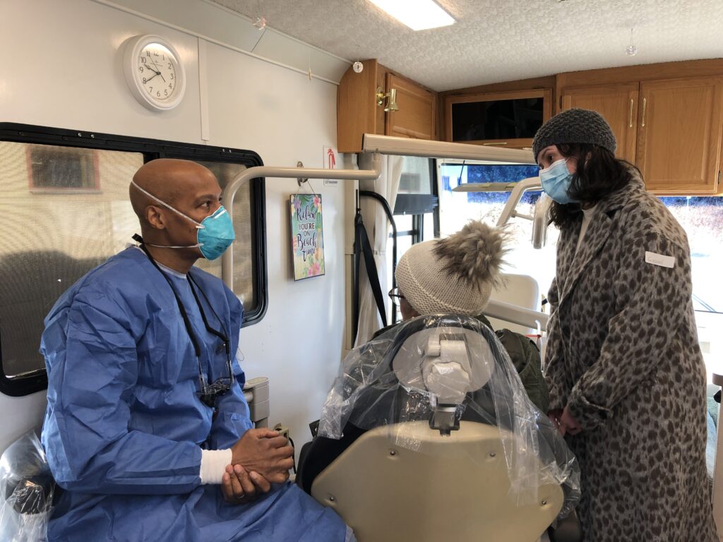 a dentist speaking to a patient