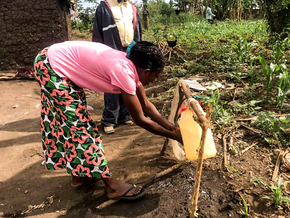 Woman washing hands with makeshift washing station