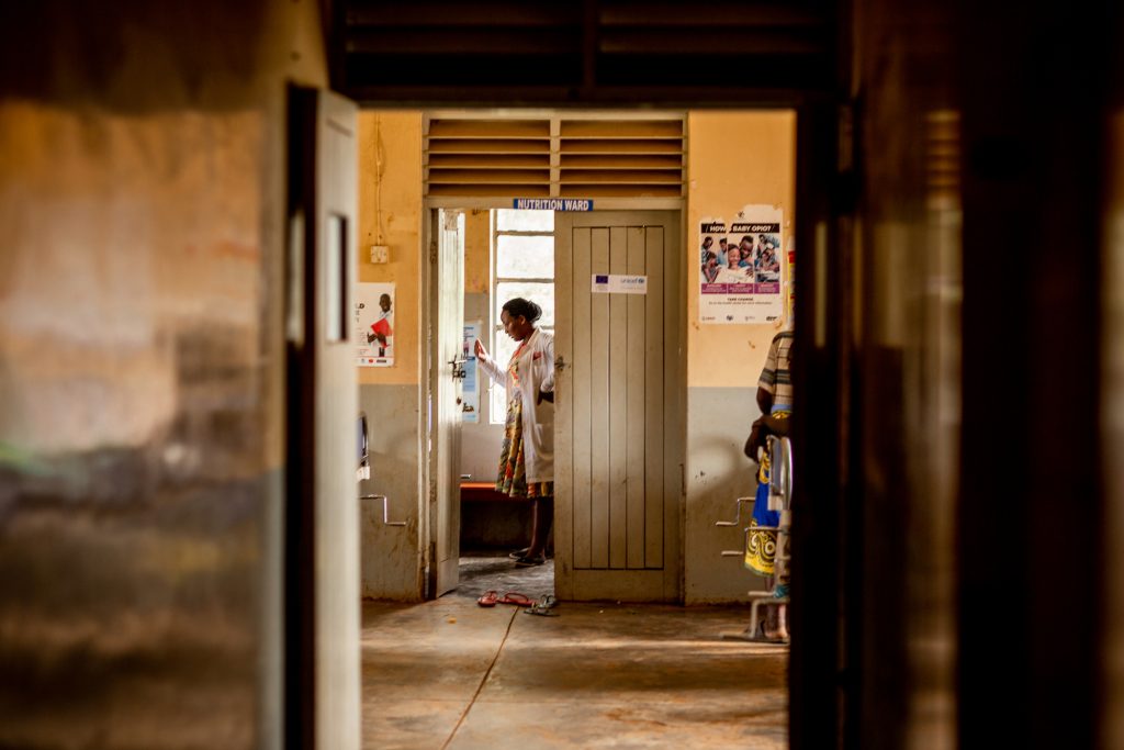 Monicah in the doorway of the nutrition ward in a medical clinic, Uganda.