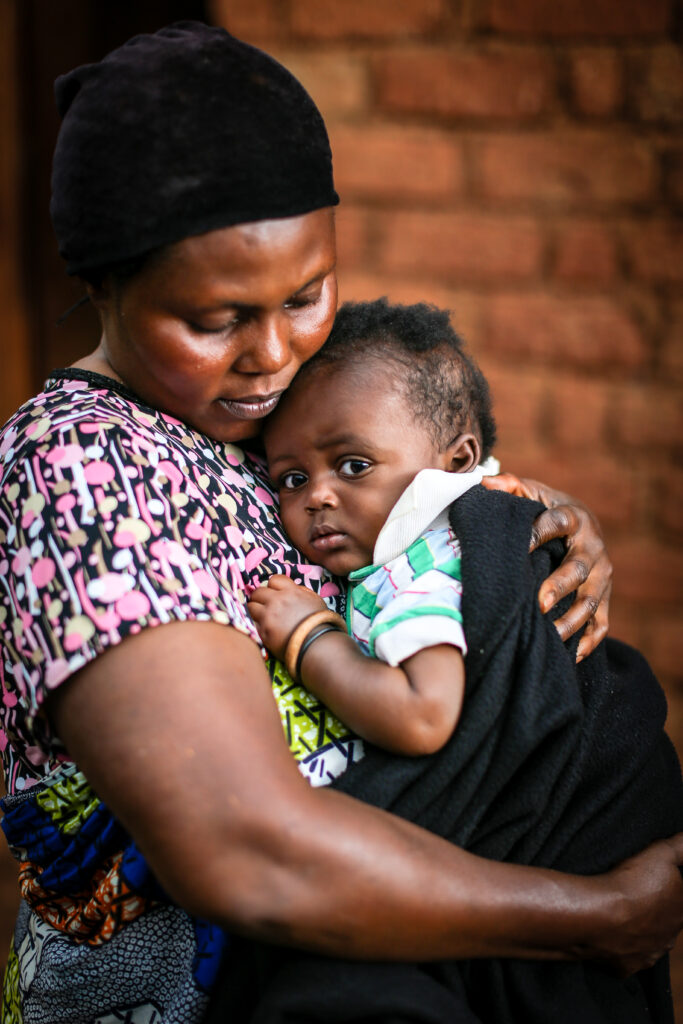 A mother holds her baby.