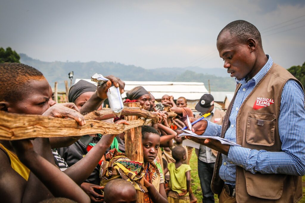 A crowd of people at a refugee camp (photo by Helen Manson)