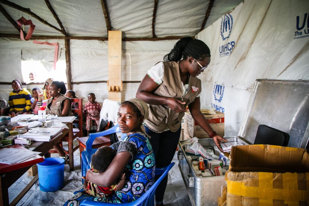 A mother, her baby and a health worker at a clinic (photo by Helen Manson)