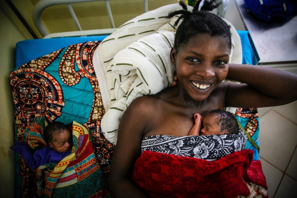 A mother with her newborn twin babies (photo by Helen Manson)